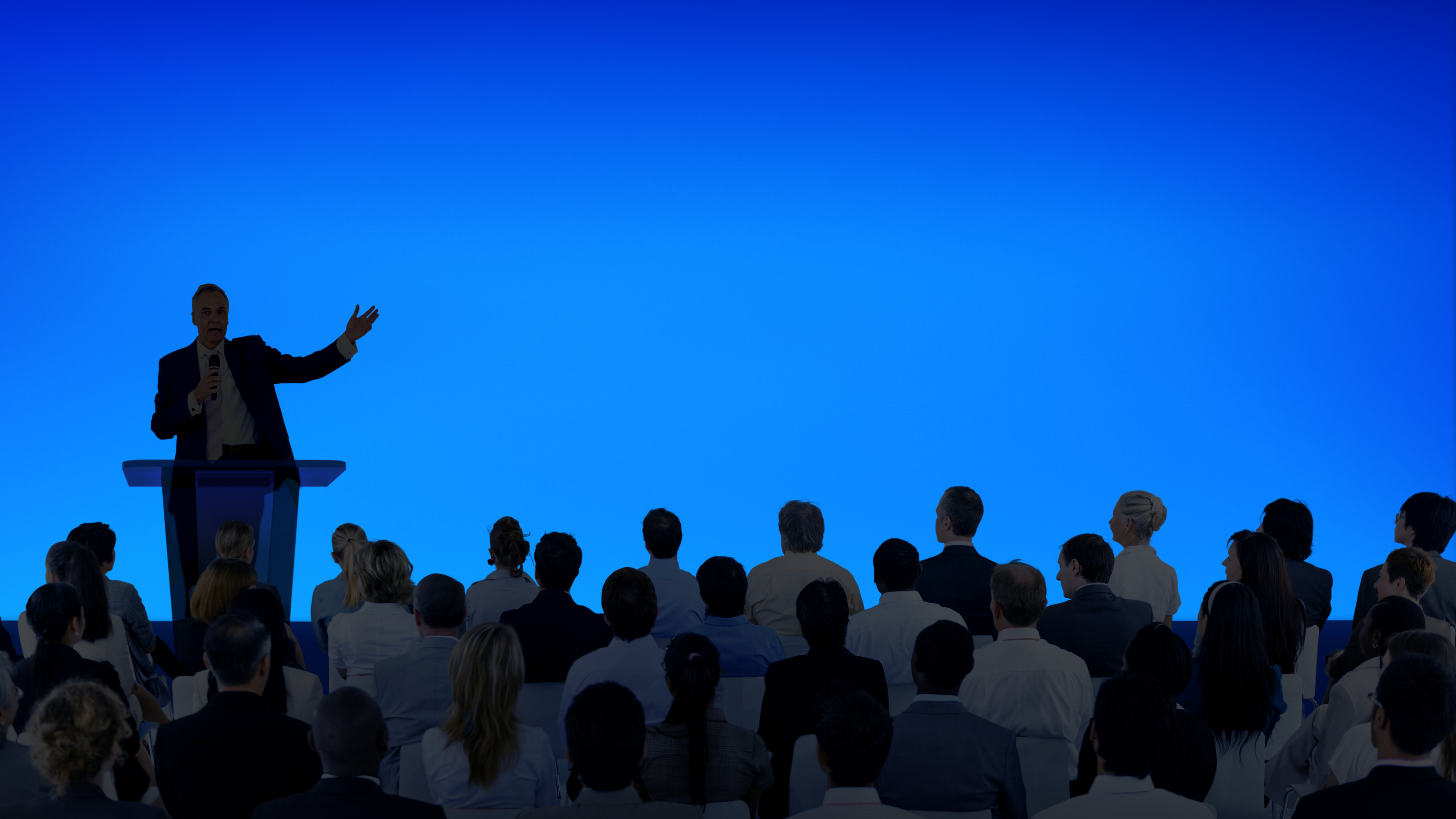1789394090_corporate-businessman-giving-presentation-large-audience.jpg